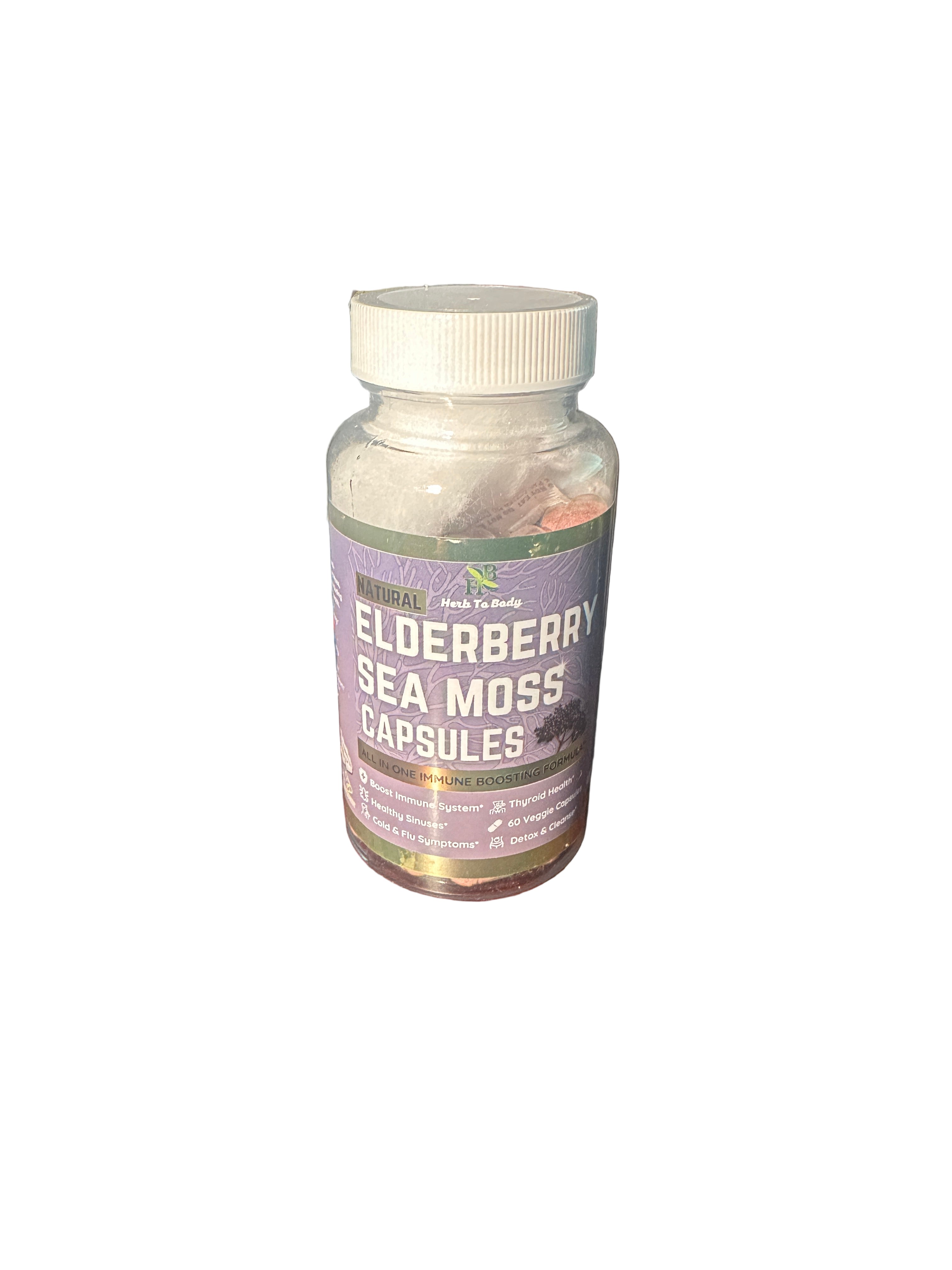 Bottle of Elderberry Sea Moss Capsules on a wooden surface with a shelf in the background.